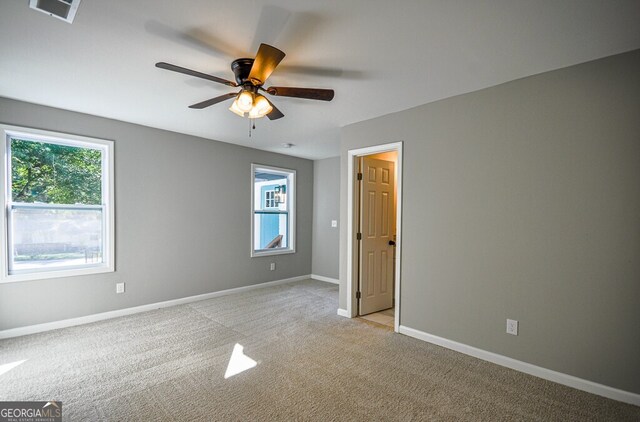 unfurnished bedroom with light carpet and ceiling fan