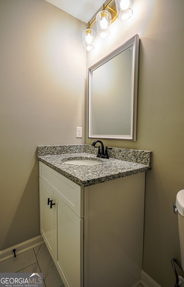 bathroom with vanity and toilet