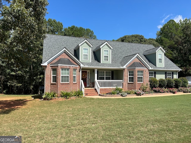 cape cod-style house with a front lawn and covered porch