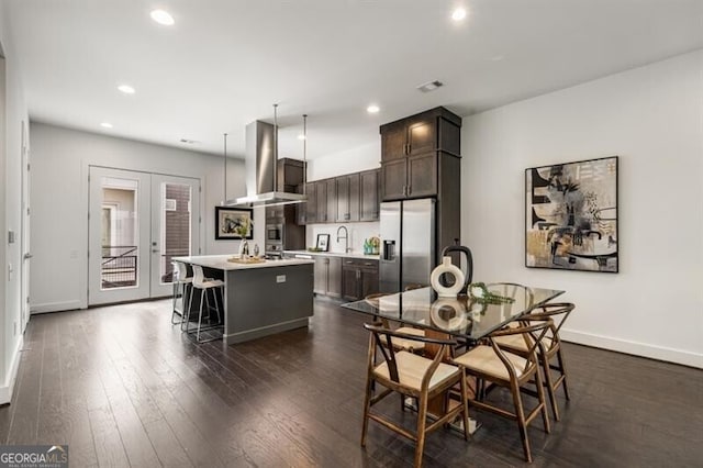 dining area with french doors, dark hardwood / wood-style floors, and sink