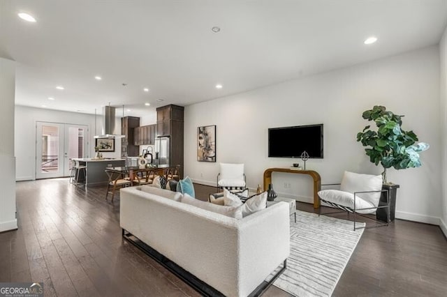 living room featuring french doors and dark wood-type flooring