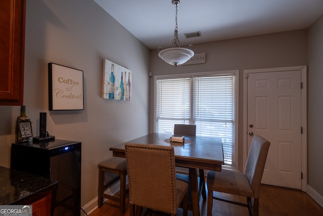 dining area with dark wood-type flooring