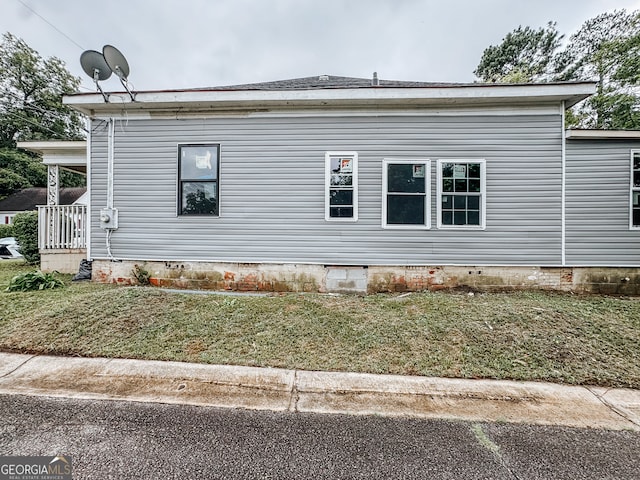 view of property exterior featuring a lawn