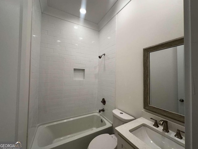 full bathroom with tiled shower / bath combo, vanity, and toilet