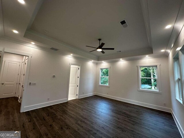 interior space featuring ornamental molding, ceiling fan, a raised ceiling, and dark hardwood / wood-style floors