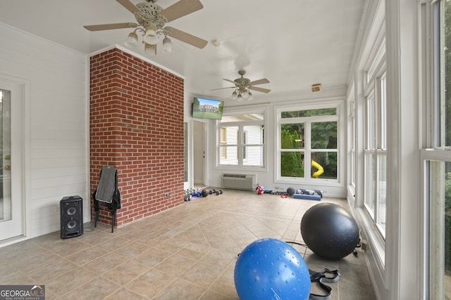 exercise area featuring ceiling fan, light tile patterned flooring, and an AC wall unit