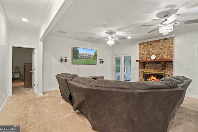 carpeted living room with ceiling fan, a fireplace, and crown molding