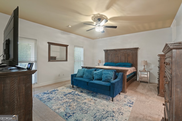 carpeted bedroom with ceiling fan and ornamental molding