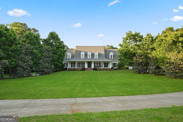 new england style home featuring a front yard