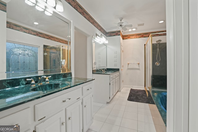 bathroom featuring ceiling fan, a shower with door, vanity, and crown molding