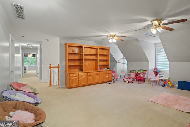 rec room featuring light carpet, lofted ceiling, and ceiling fan