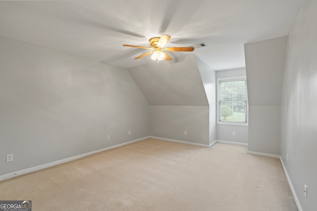 bonus room with lofted ceiling, light carpet, and ceiling fan