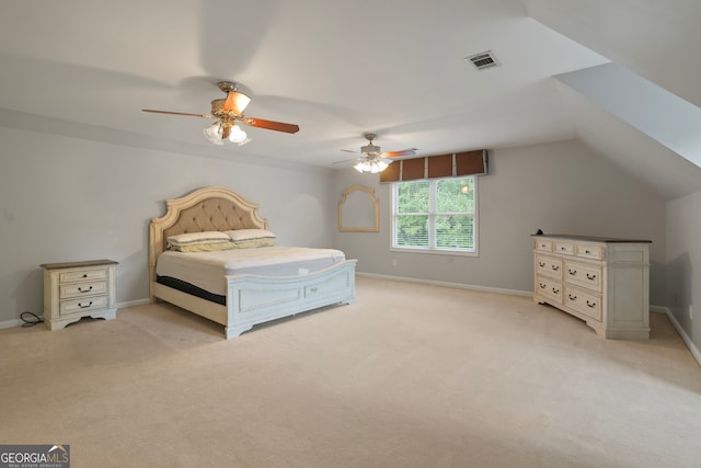 unfurnished bedroom with ceiling fan, light colored carpet, and vaulted ceiling