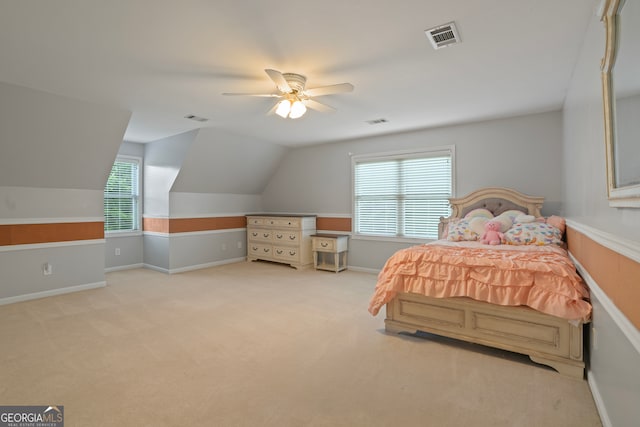 bedroom with ceiling fan, light colored carpet, vaulted ceiling, and multiple windows