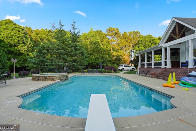 view of pool featuring an in ground hot tub, a patio area, and a diving board