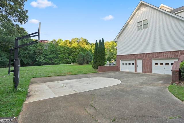 view of side of property with a garage and a yard