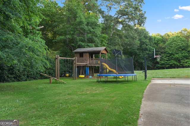 view of jungle gym featuring a lawn and a trampoline