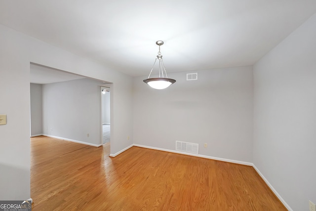 unfurnished room featuring wood-type flooring