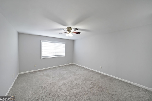 carpeted empty room featuring ceiling fan