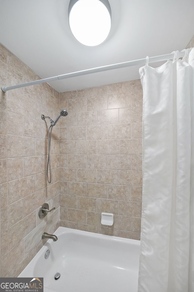 bathroom with shower / tub combo with curtain