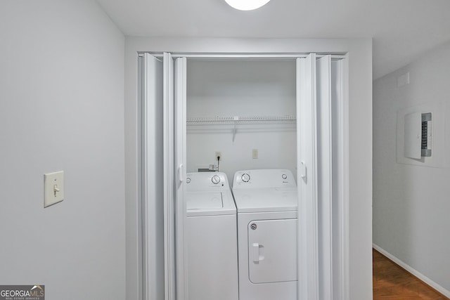 laundry area with washer and dryer and dark hardwood / wood-style flooring