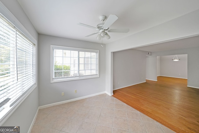 unfurnished room with ceiling fan and light hardwood / wood-style floors