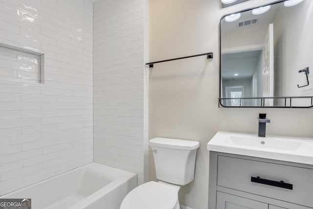 full bathroom with vanity, toilet, and tiled shower / bath combo