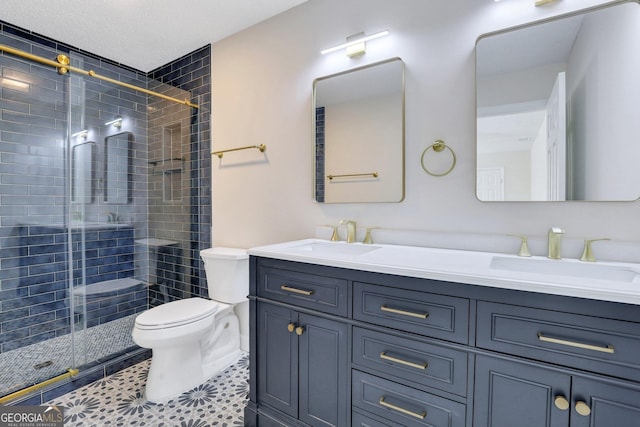 bathroom featuring tile patterned flooring, vanity, toilet, and an enclosed shower