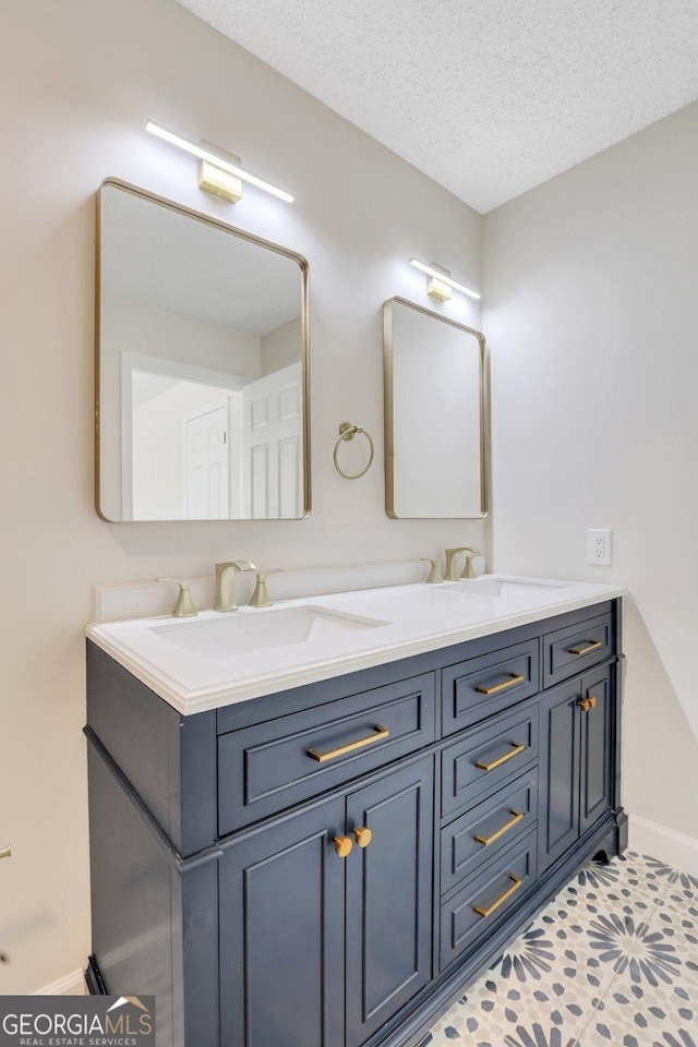 bathroom with vanity, a textured ceiling, and tile patterned floors