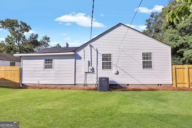 back of house with a yard and cooling unit