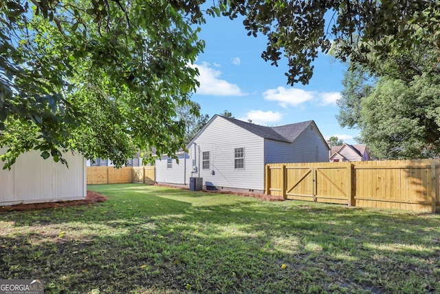 rear view of property with a lawn and central AC