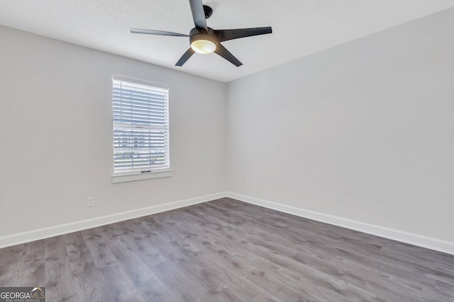 unfurnished room with hardwood / wood-style floors and ceiling fan