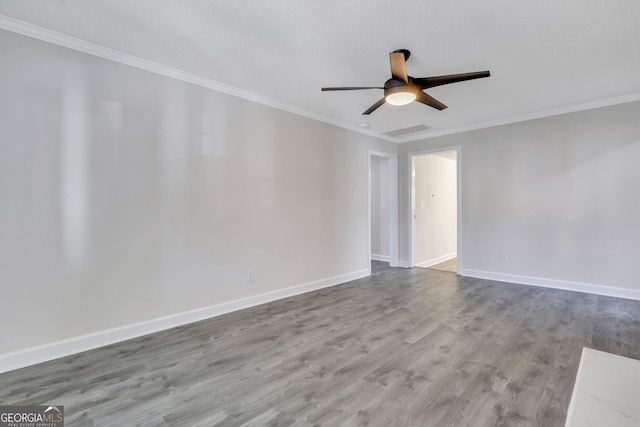 empty room with ceiling fan, wood-type flooring, a textured ceiling, and ornamental molding