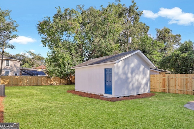 view of outdoor structure with a lawn and cooling unit