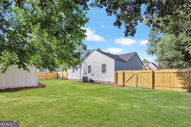 back of house with a lawn and central AC