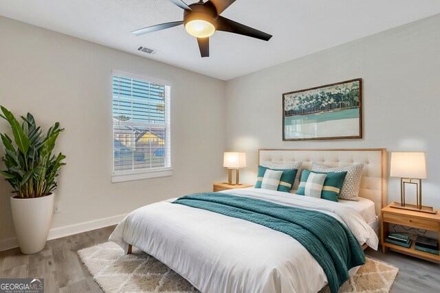 bedroom with hardwood / wood-style floors and ceiling fan