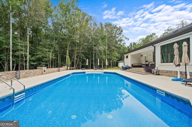 view of swimming pool featuring a patio