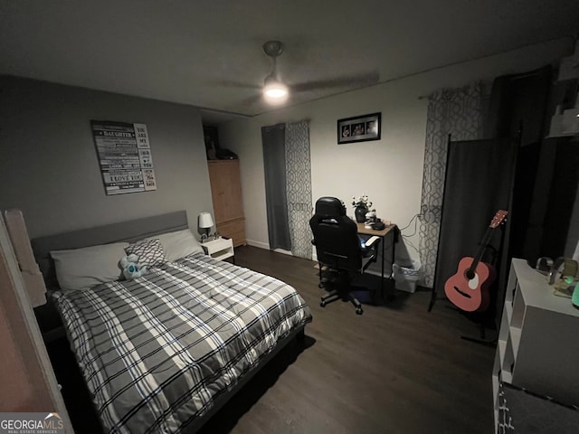 bedroom featuring ceiling fan and dark wood-type flooring