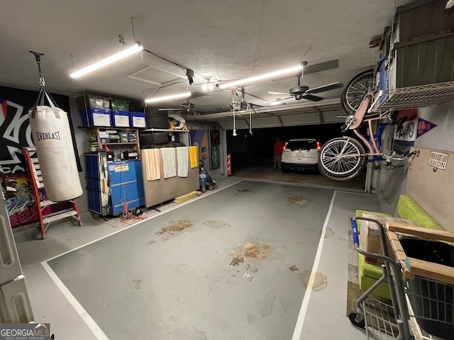 garage with a garage door opener and ceiling fan