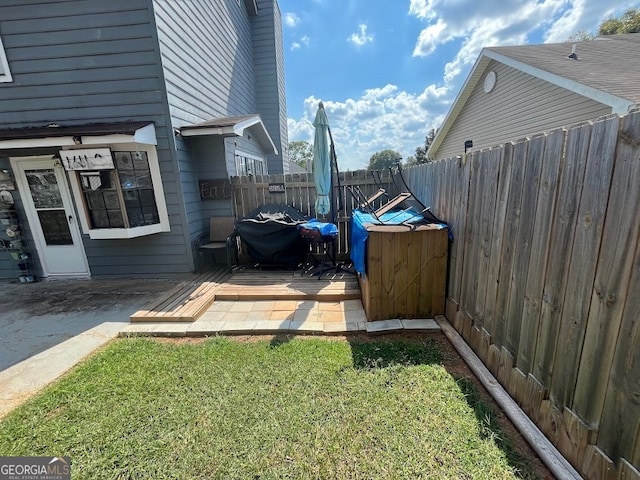 view of side of property featuring a yard and a wooden deck