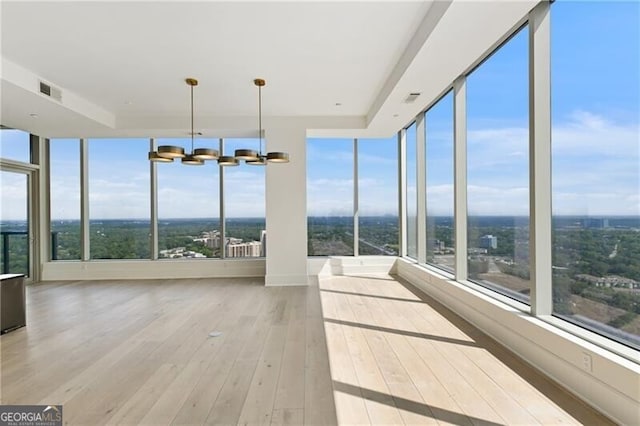 unfurnished sunroom with a notable chandelier