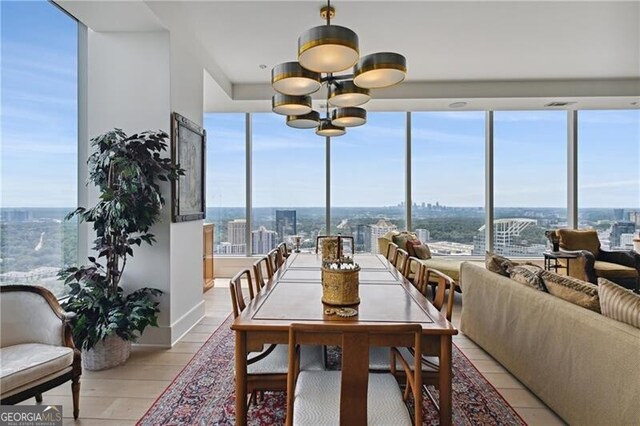 dining area with a notable chandelier and light wood-type flooring