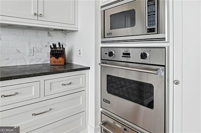 3630 Peachtree Rd Unit Ph3302, Atlanta, GA 30326 - kitchen with stainless steel appliances, tasteful backsplash, white cabinets, and dark stone counters