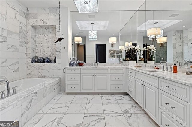 bathroom with tiled bath and vanity