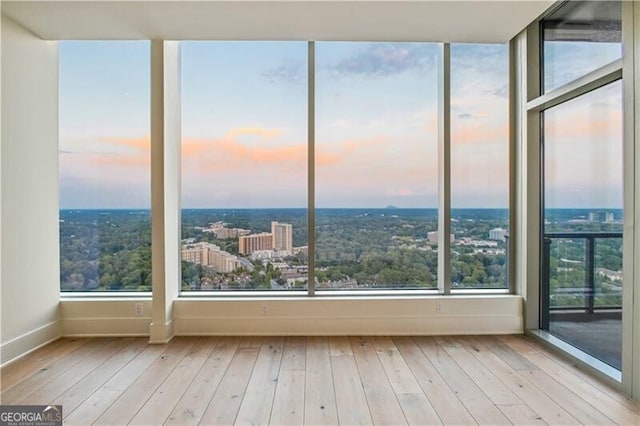 3630 Peachtree Rd Unit Ph3302, Atlanta, GA 30326 - unfurnished sunroom featuring baseboards, hardwood / wood-style flooring, and a view of city
