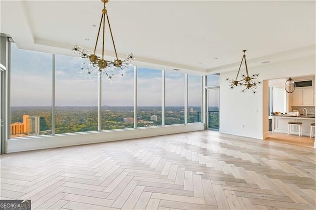 3630 Peachtree Rd Unit Ph3302, Atlanta, GA 30326 - unfurnished living room with a chandelier, floor to ceiling windows, and a sink