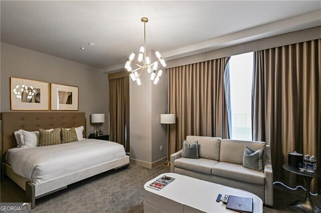 bedroom with a notable chandelier and dark carpet