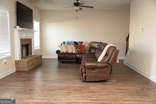 living room with ceiling fan, a fireplace, and hardwood / wood-style floors