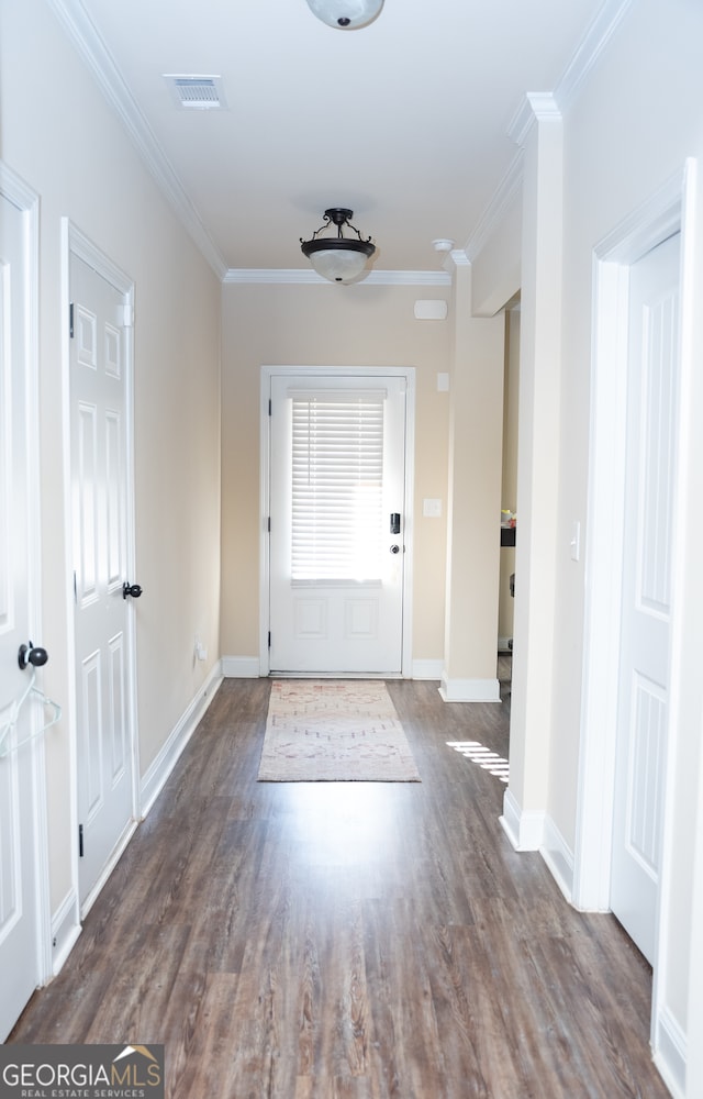 doorway with dark hardwood / wood-style floors and crown molding