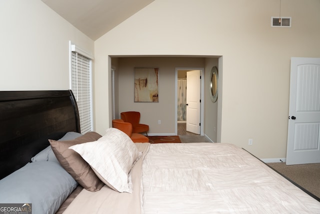 carpeted bedroom featuring high vaulted ceiling